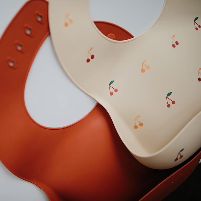 mushie Silicone Baby Bib | Adjustable Fit Waterproof Bibs (Cherries)