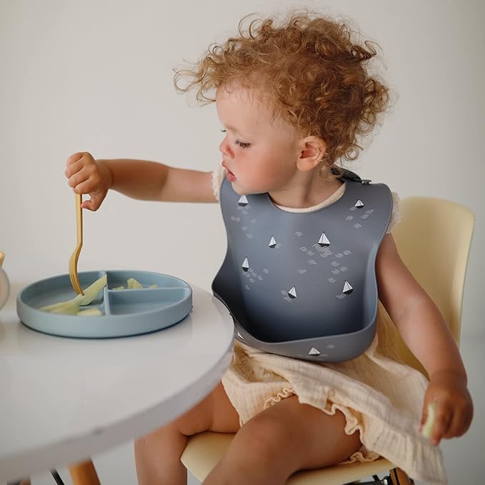 mushie Silicone Baby Bib | Adjustable Fit Waterproof Bibs (Boats)