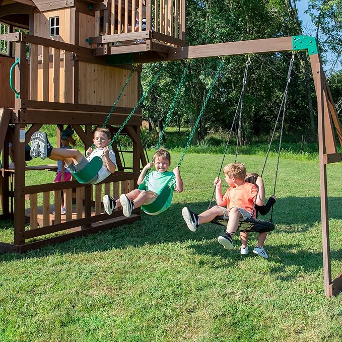 Backyard Discovery Skyfort All Cedar Swing Set, Elevated Covered Wood Roof Clubhouse with Bay Windows, 2 Belt Swings, Web Swing, 10ft Wave Slide, 5 ft Tube Slide, Covered Picnic Table, 5 ft Rock Wall